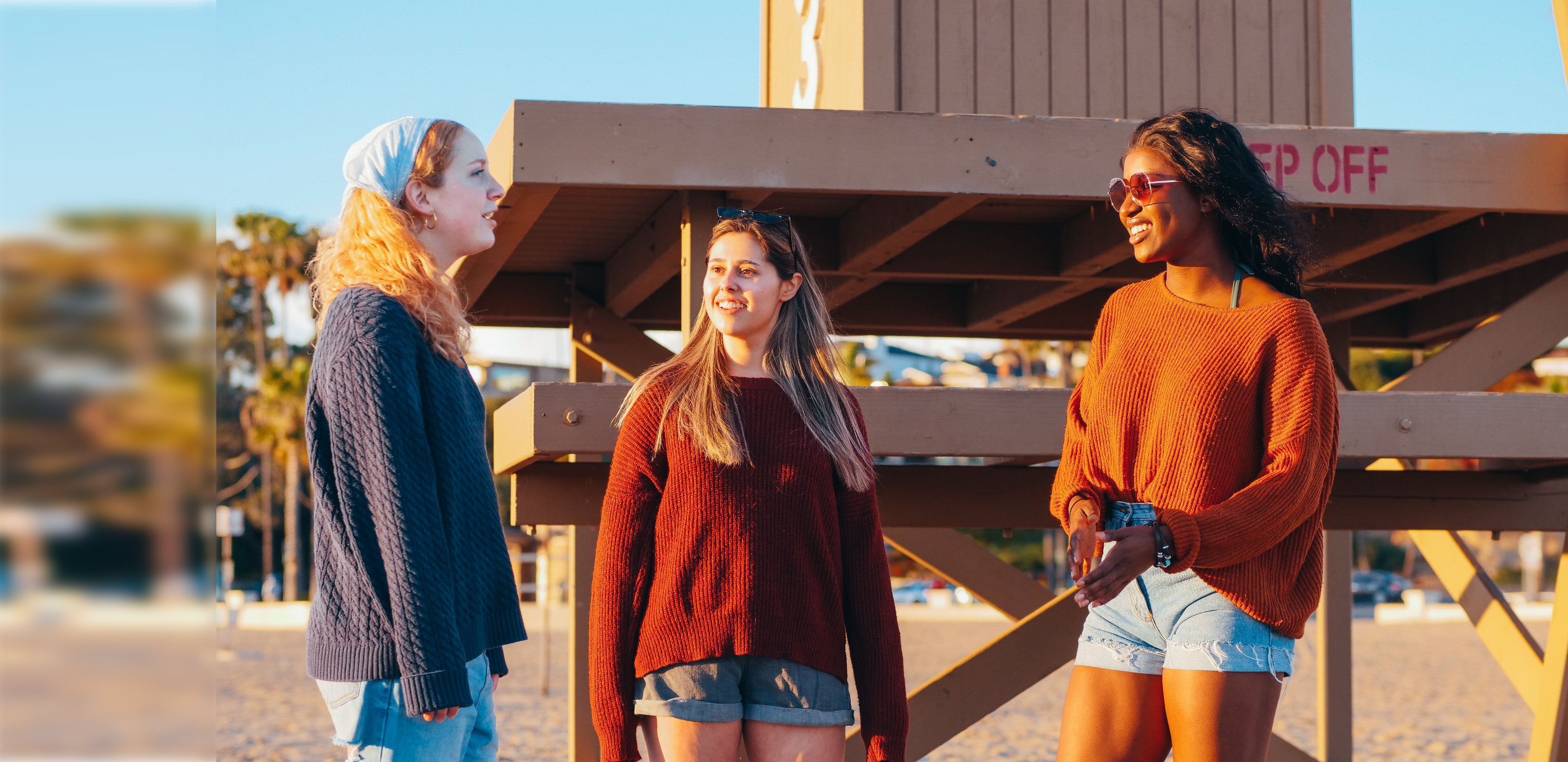 Three caregivers talk in golden light