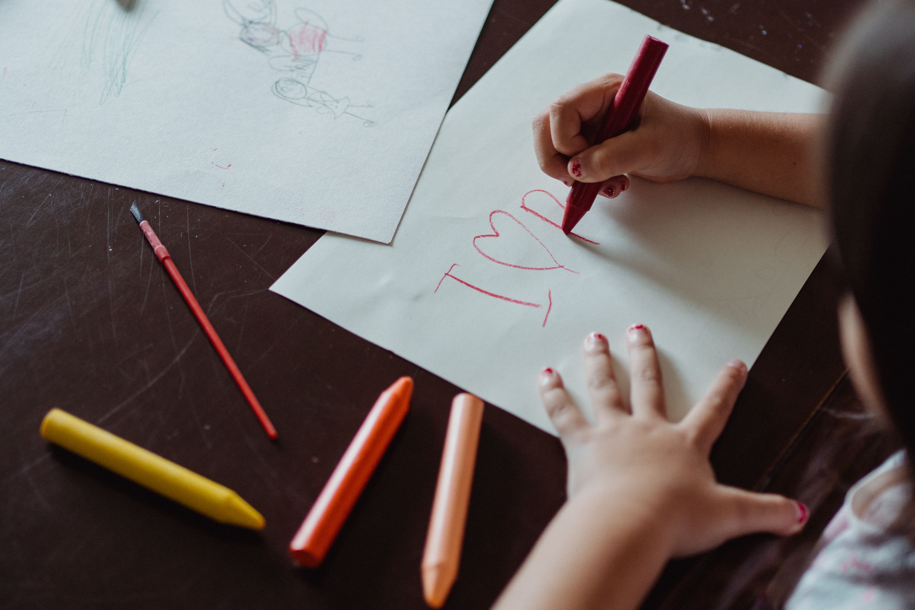 A hand marking a family planner